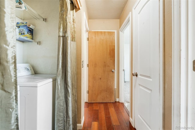 clothes washing area featuring washer / dryer, wood finished floors, and laundry area
