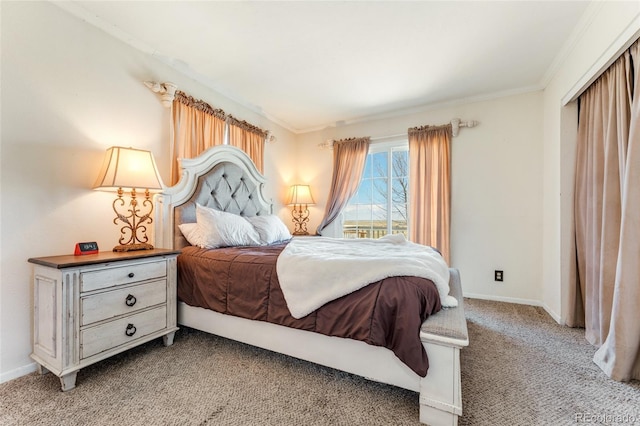 carpeted bedroom featuring baseboards and ornamental molding