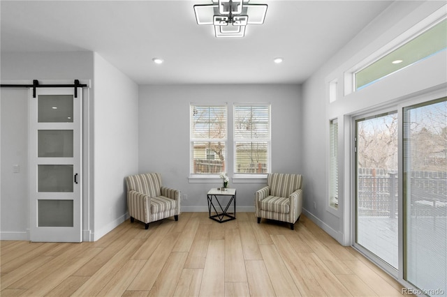 12215 Viewpoint Dr, Lakewood, CO 80401 - sitting room featuring a barn door, recessed lighting, baseboards, and light wood-style floors