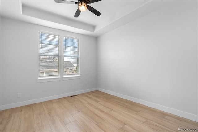 12215 Viewpoint Dr, Lakewood, CO 80401 - empty room featuring a tray ceiling, baseboards, light wood finished floors, and ceiling fan