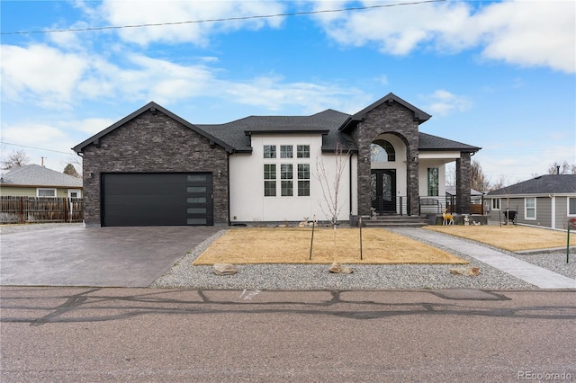 12215 Viewpoint Dr, Lakewood, CO 80401 - view of front of house featuring fence, an attached garage, stucco siding, concrete driveway, and stone siding