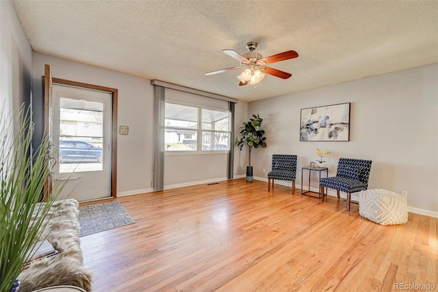 2601 Cooper Ave, Colorado Springs, CO 80907 - sitting room featuring a textured ceiling, light wood-style flooring, ceiling fan, and baseboards