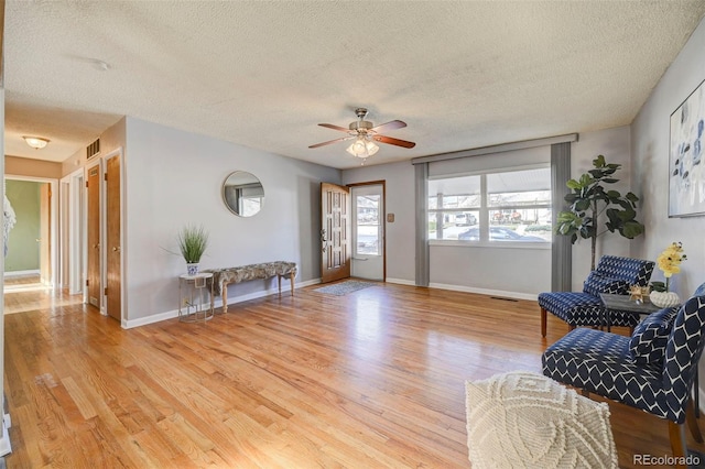 2601 Cooper Ave, Colorado Springs, CO 80907 - living area with a textured ceiling, wood finished floors, ceiling fan, and baseboards