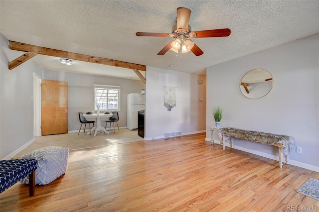 2601 Cooper Ave, Colorado Springs, CO 80907 - living area featuring a textured ceiling, wood finished floors, a ceiling fan, and baseboards