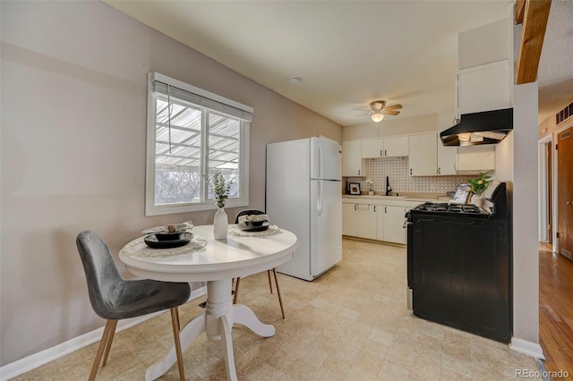 2601 Cooper Ave, Colorado Springs, CO 80907 - kitchen featuring freestanding refrigerator, ventilation hood, black gas range, a sink, and a ceiling fan