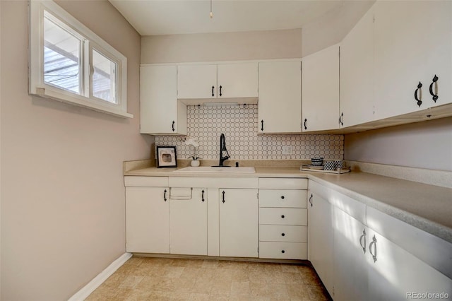 2601 Cooper Ave, Colorado Springs, CO 80907 - kitchen featuring a sink, decorative backsplash, and light countertops