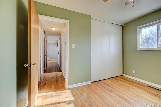 2601 Cooper Ave, Colorado Springs, CO 80907 - unfurnished bedroom featuring wood finished floors, a closet, baseboards, and ceiling fan