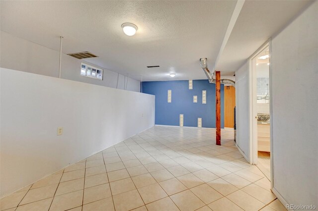 2601 Cooper Ave, Colorado Springs, CO 80907 - finished basement with a textured ceiling and light tile patterned flooring