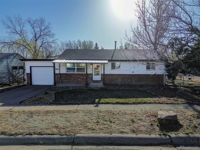 2601 Cooper Ave, Colorado Springs, CO 80907 - single story home with brick siding, an attached garage, and concrete driveway