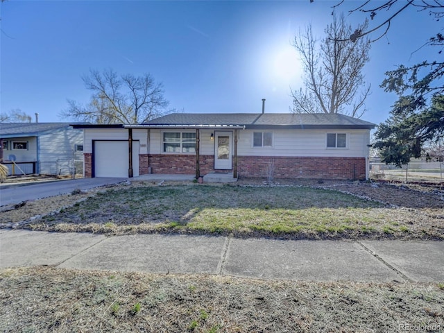 2601 Cooper Ave, Colorado Springs, CO 80907 - ranch-style home featuring brick siding, an attached garage, and driveway