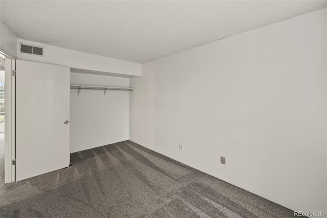 3110 Van Teylingen Dr Unit C, Colorado Springs, CO 80917 - unfurnished bedroom featuring dark colored carpet, a closet, and a textured ceiling