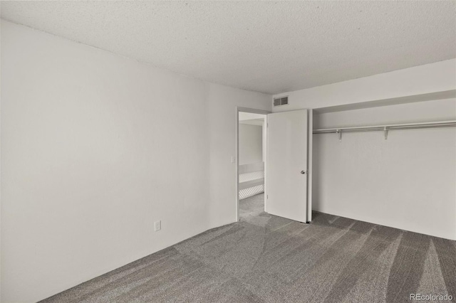 3110 Van Teylingen Dr Unit C, Colorado Springs, CO 80917 - unfurnished bedroom featuring dark colored carpet, a textured ceiling, and a closet