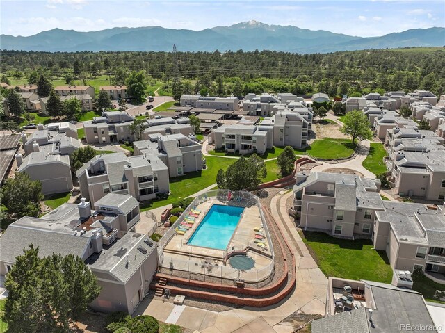 3110 Van Teylingen Dr Unit C, Colorado Springs, CO 80917 - aerial view of residential area with a mountainous background, a pool area, and a forest