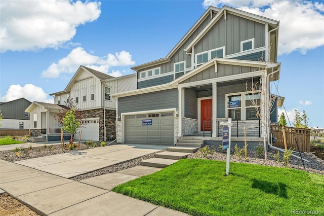 craftsman house with a garage, a porch, and a front lawn