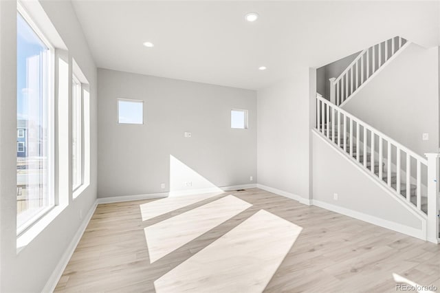 empty room with light hardwood / wood-style flooring