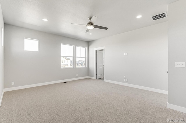 empty room with ceiling fan and light colored carpet