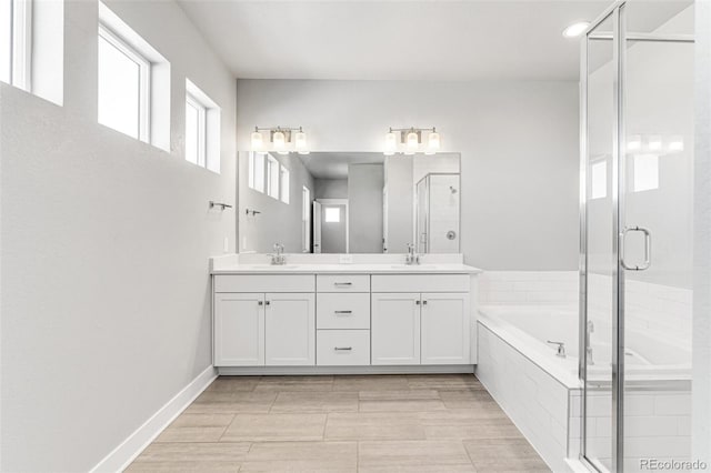 bathroom with shower with separate bathtub and vanity