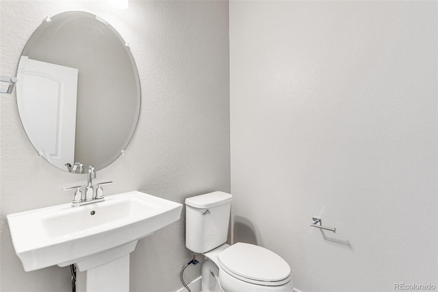 bathroom featuring sink and toilet