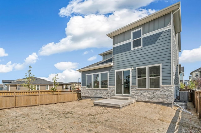 rear view of house with cooling unit and a patio area