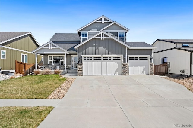 208 Dorothy Dr, Berthoud, CO 80513 - craftsman-style house with concrete driveway, a front lawn, stone siding, and a shingled roof