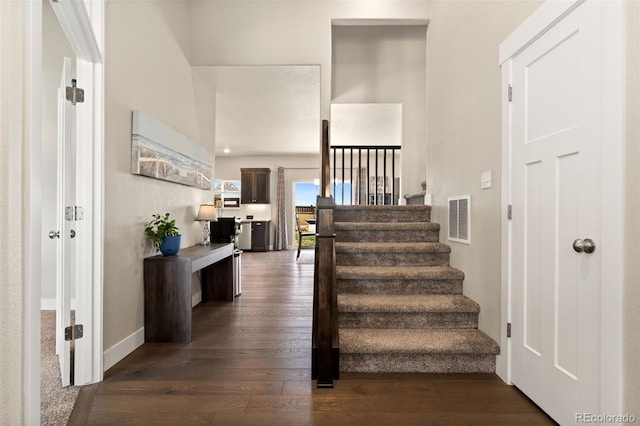 208 Dorothy Dr, Berthoud, CO 80513 - staircase with baseboards, wood-type flooring, and visible vents