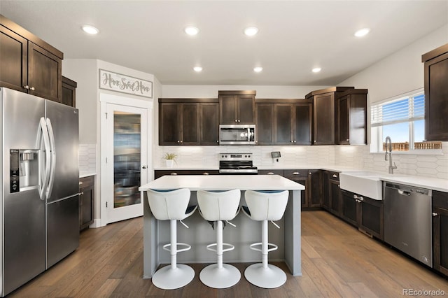 208 Dorothy Dr, Berthoud, CO 80513 - kitchen featuring a center island, appliances with stainless steel finishes, a sink, and dark brown cabinets