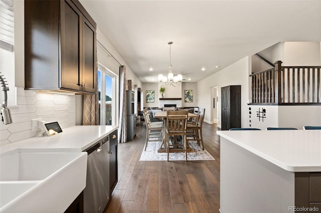 208 Dorothy Dr, Berthoud, CO 80513 - kitchen with open floor plan, light countertops, a fireplace, dark wood-style floors, and stainless steel dishwasher