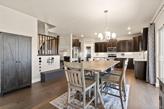 208 Dorothy Dr, Berthoud, CO 80513 - dining room with stairs, a notable chandelier, dark wood-style floors, and recessed lighting