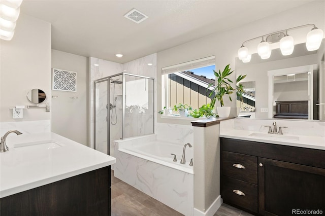 208 Dorothy Dr, Berthoud, CO 80513 - bathroom with a garden tub, two vanities, visible vents, a sink, and a marble finish shower