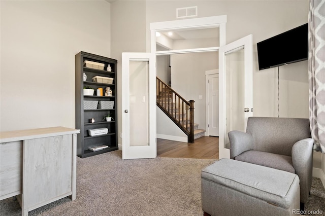 208 Dorothy Dr, Berthoud, CO 80513 - sitting room featuring a towering ceiling, visible vents, stairway, carpet floors, and baseboards
