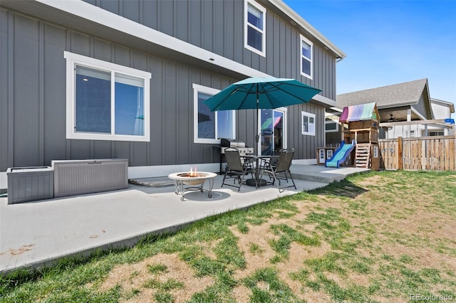 208 Dorothy Dr, Berthoud, CO 80513 - rear view of house with board and batten siding and a playground