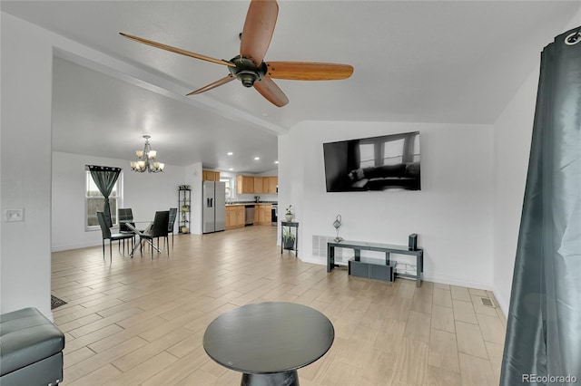 243 Cherokee Ct, Brighton, CO 80603 - living area featuring a chandelier, vaulted ceiling, a ceiling fan, light wood-type flooring, and baseboards