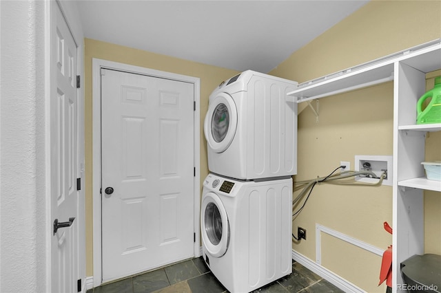 243 Cherokee Ct, Brighton, CO 80603 - laundry room featuring stacked washer / dryer