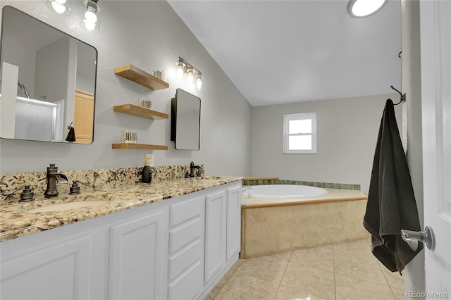 243 Cherokee Ct, Brighton, CO 80603 - full bathroom with lofted ceiling, a garden tub, a shower stall, double vanity, and tile patterned flooring