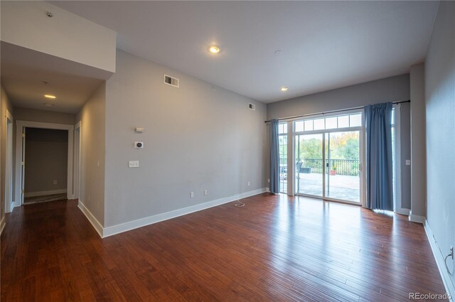 spare room with baseboards, visible vents, wood finished floors, and recessed lighting