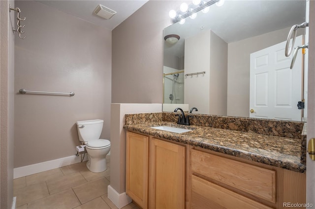 bathroom featuring visible vents, toilet, a stall shower, vanity, and tile patterned flooring