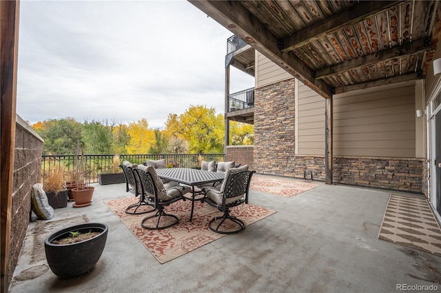 view of patio / terrace featuring a balcony and outdoor dining area