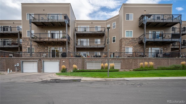 6000 W Floyd Ave Unit 107, Denver, CO 80227 - view of apartment building / complex with an attached garage and driveway