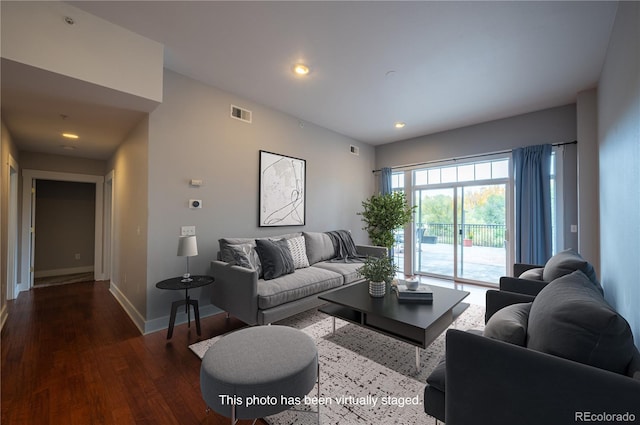 living room featuring recessed lighting, wood finished floors, visible vents, and baseboards