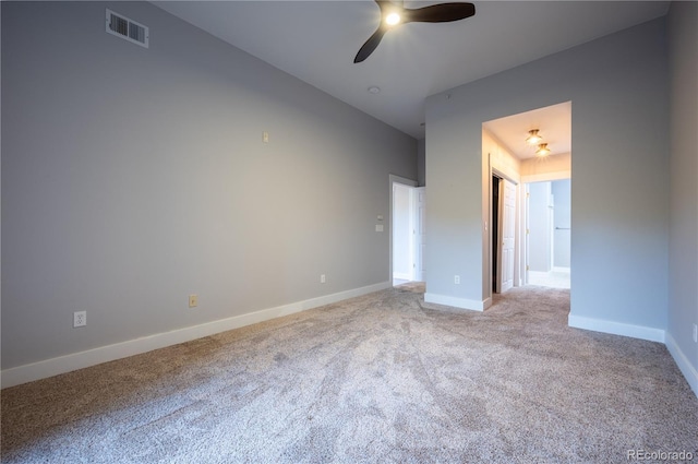 unfurnished bedroom with a ceiling fan, visible vents, light carpet, and baseboards