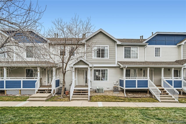 townhome / multi-family property featuring a porch, a front lawn, and central air condition unit