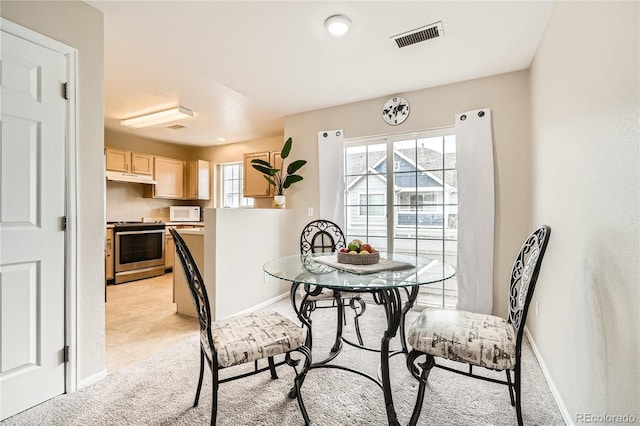 dining area with a healthy amount of sunlight and light colored carpet