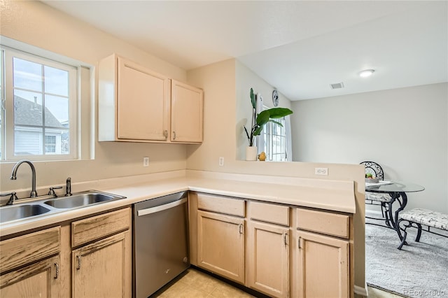 kitchen with stainless steel dishwasher, light brown cabinets, kitchen peninsula, and sink