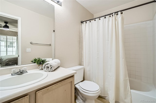 full bathroom with ceiling fan, vanity, shower / tub combo, and toilet