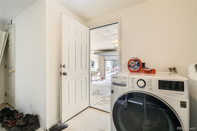 clothes washing area with washer and clothes dryer