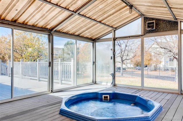 sunroom / solarium featuring a jacuzzi and lofted ceiling