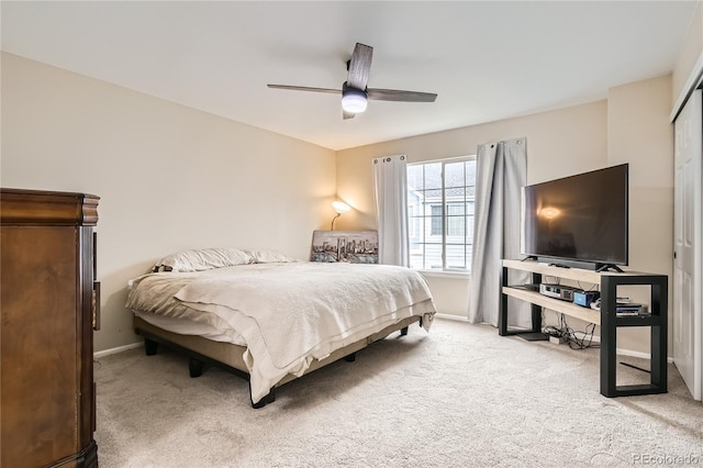 bedroom with ceiling fan and light carpet