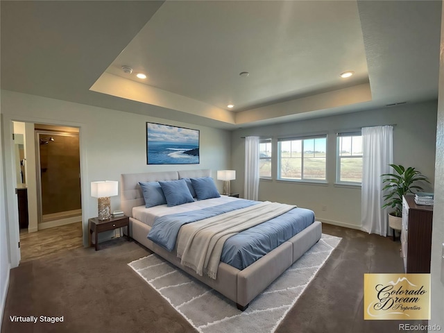 bedroom with a tray ceiling, dark carpet, baseboards, and recessed lighting