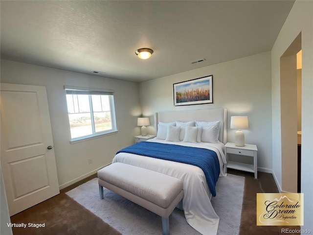 carpeted bedroom with visible vents and baseboards