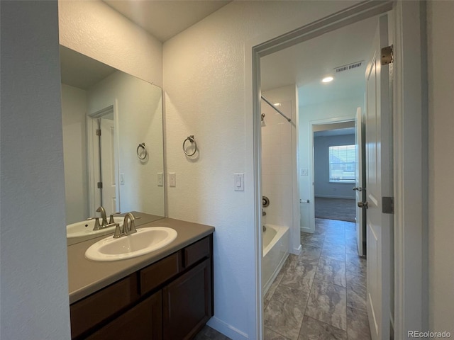 full bath featuring bathing tub / shower combination, vanity, visible vents, and baseboards